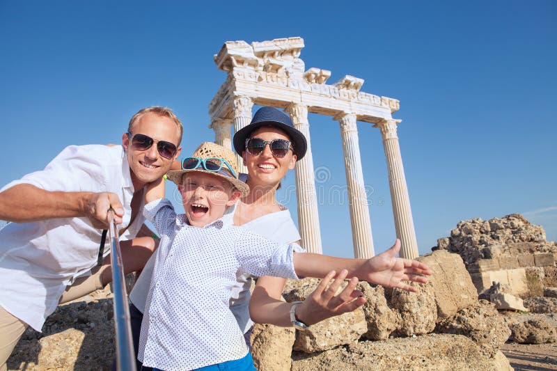 Positive young family take a selfie photo near antique Ñolonnade